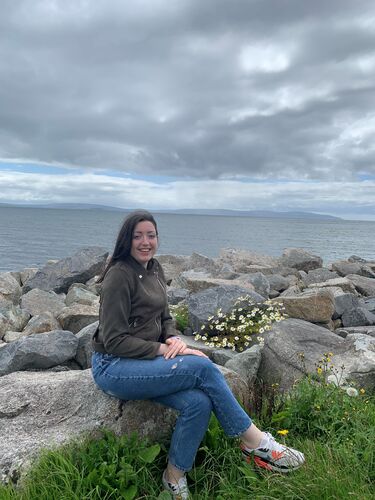 Emily Larkin sitting by the sea