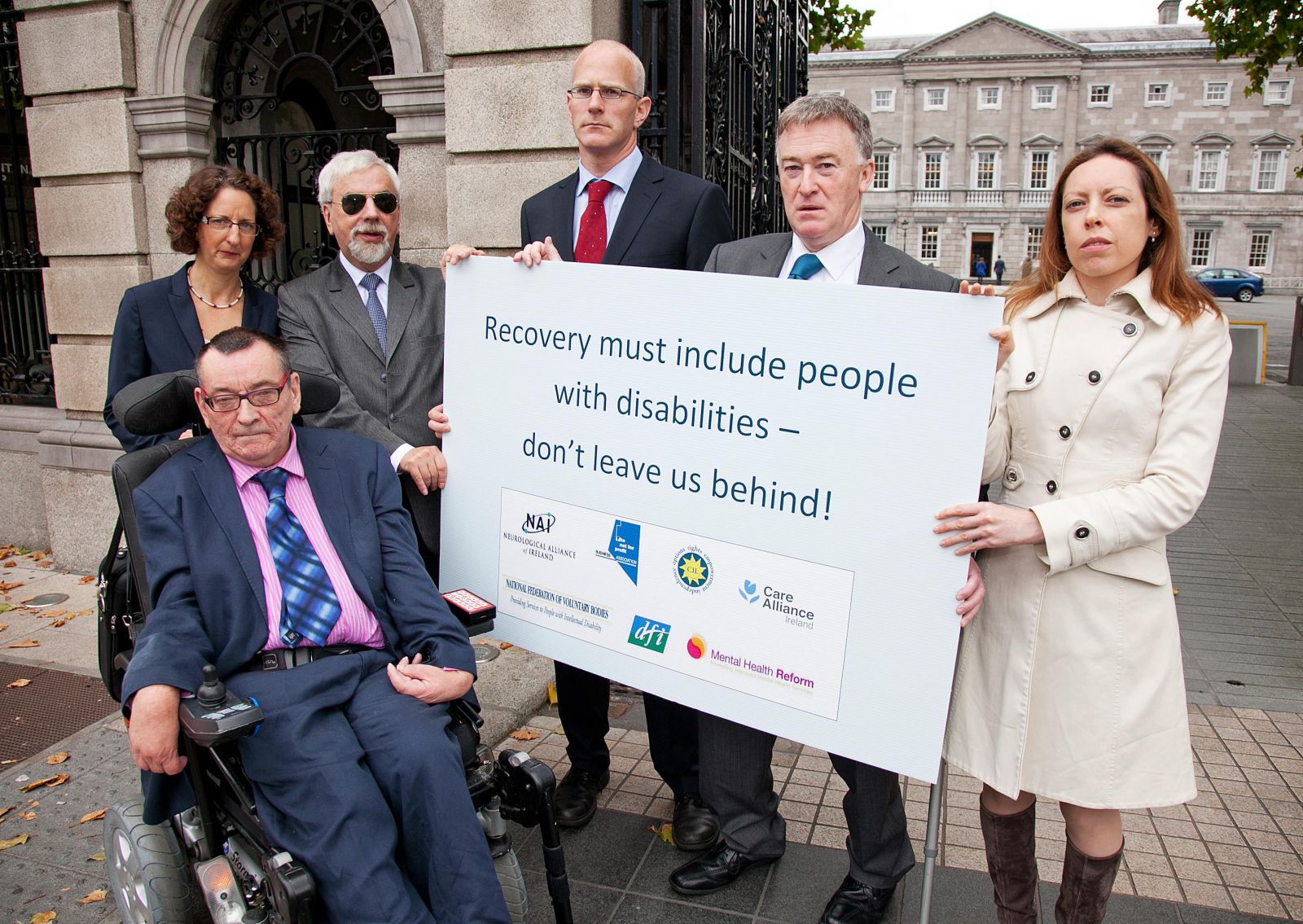 Sign stating: Recovery must include people with disabilities - don't leave us behind: held by Michael McCabe: Center for Independent Living, Shari McDaid : Mental Health Reform, Des Kenny : Not for Profit Business Association, Liam O'Sullivan : Care Alliance Ireland, John Dolan : Disability Federation of Ireland, Mags Rogers : Neurological Alliance of Ireland